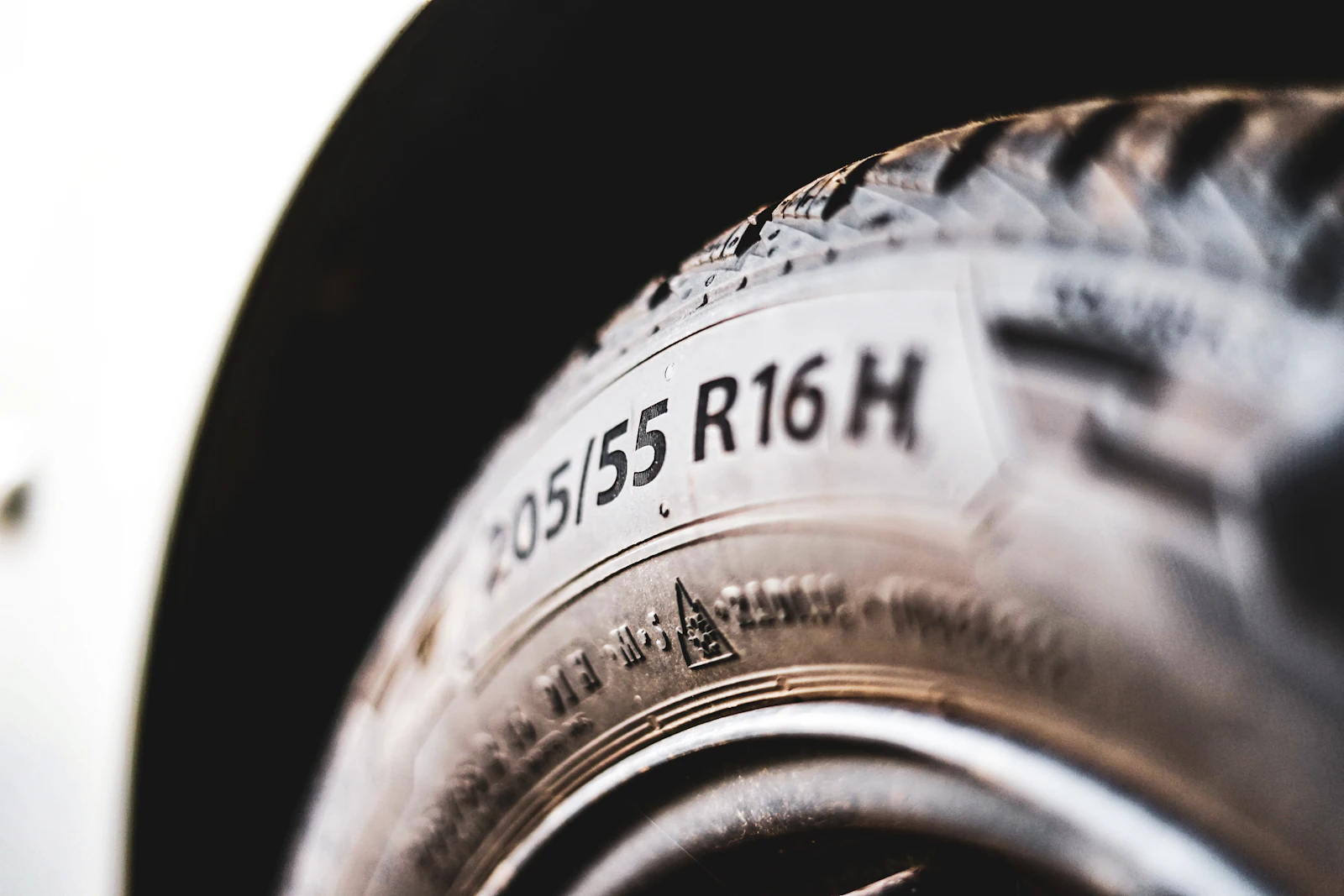 Tire sidewall with the size marking 205/55 R16 molded into the rubber
