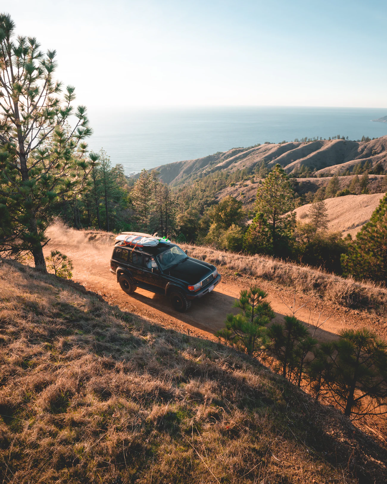 SUV on all-terrain tires climbing a dirt road