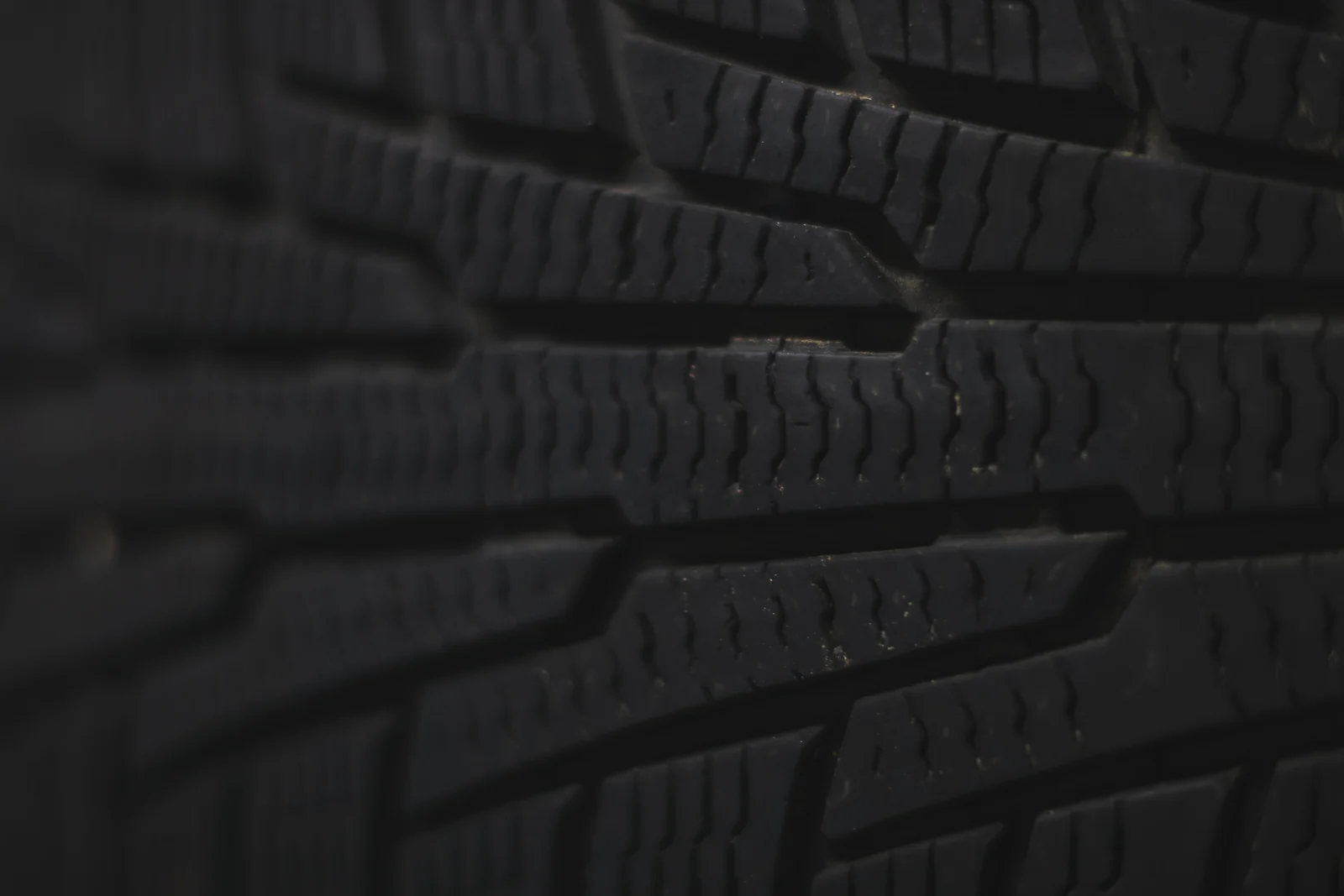Close-up of a tire tread with zigzag sipes